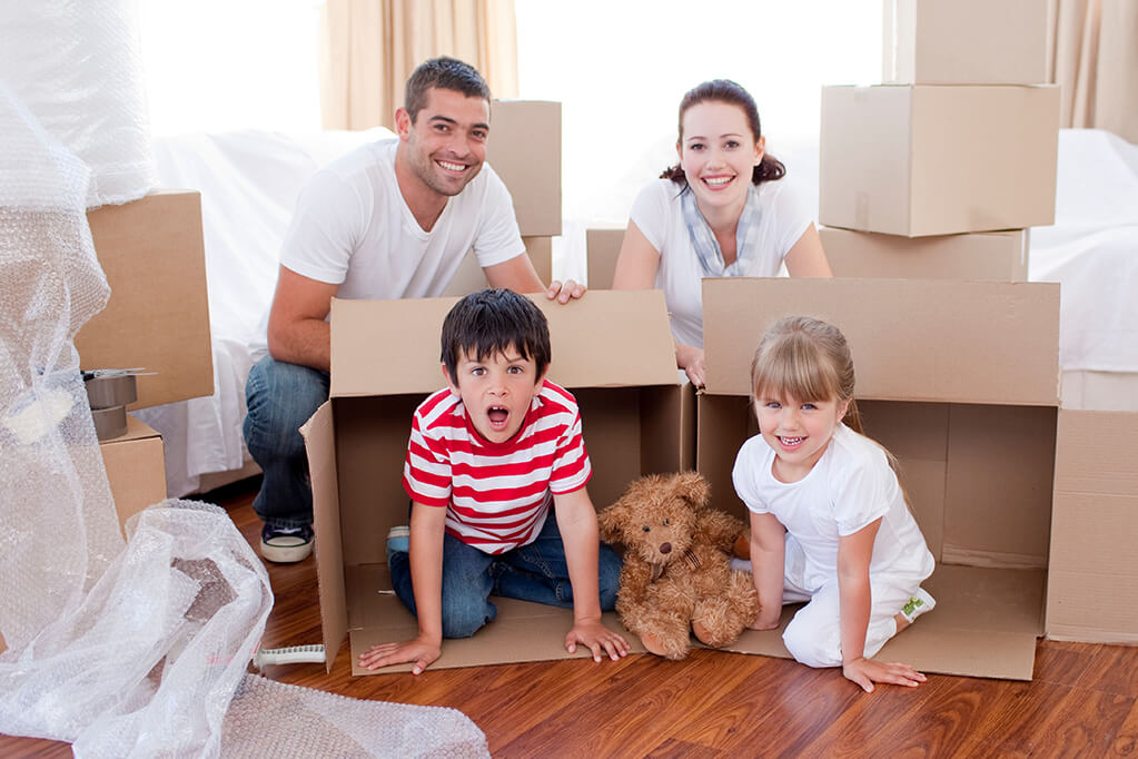 Family moving house with boxes